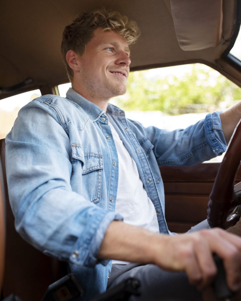 smiley-man-driving-car-medium-shot